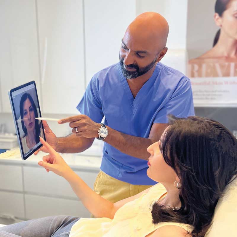 Dr Raman planning a lip filler treatment with a patient in London